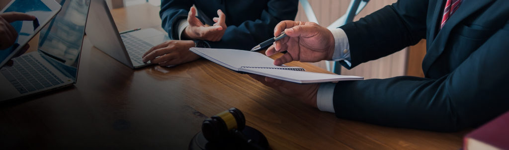 Investment lawyer discusses recovery options with client.