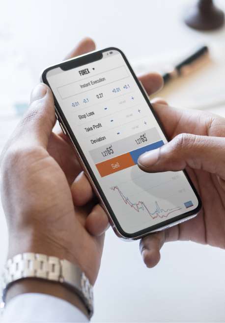 Up-close image of hands holding a smart phone with a stock ticker.